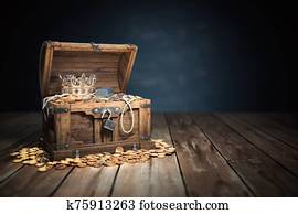 Open treasure chest filled with golden coins, gold and jewelry. Open treasure chest filled with golden coins, gold and jewelry.