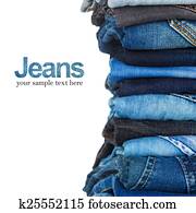 stack of various shades of blue jeans on white background