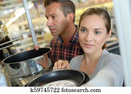 shoppers choosing pans in professional wholesale store shoppers choosing pans in professional wholesale store