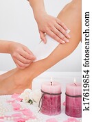 Beautician Waxing A Woman's Leg Beautician Waxing A Woman's Leg