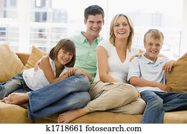 Family sitting in living room smiling Family sitting in living room smiling