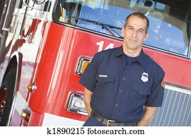 Portrait of a firefighter by a fire engine Portrait of a firefighter by a fire engine
