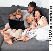 Family on a sofa with laptop