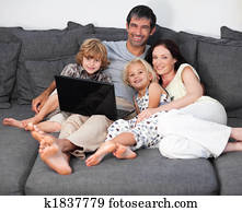 Family on a sofa with laptop