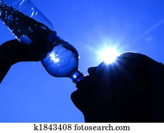 woman drinking water in the sun woman drinking water in the sun