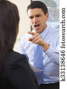 Aggressive Businessman Shouting At Female Colleague