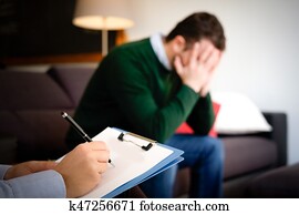 Man with mental health problem in the psychiatrist studio Man with mental health problem in the psychiatrist studio