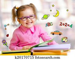 Happy child girl in glasses reading books in library Happy child girl in glasses reading books in library