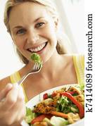 Mid Adult Woman Eating A Healthy Salad