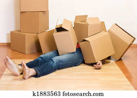 Man covered in cardboard boxes - moving concept Man covered in cardboard boxes - moving concept