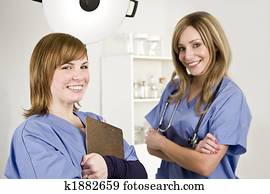 nurse and doctor in a white hospital room