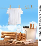 Laundry day with towels, clothespins on table 