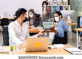 Social distance office with business team wear face mask as new normal life Social distance office with business team wear face mask as new normal life