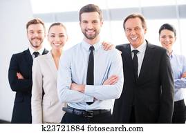 Successful business team. Group of confident business people in formal wear standing close to each other and smiling