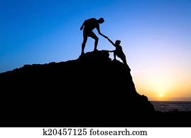 Man and woman help silhouette in mountains Man and woman help silhouette in mountains