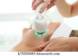 Photonic ultrasonic facial massage. Ultrasonic facial massage, light phototherapy. Photonic ultrasonic facial massage. Ultrasonic facial massage, light phototherapy.