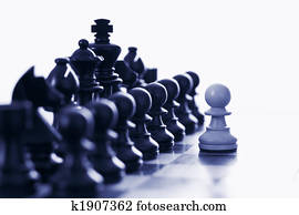 White pawn challenging black chess pieces White pawn challenging black chess pieces