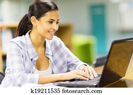 female university student using laptop computer