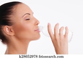 Attractive healthy woman with perfect skin is thirsty
