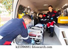 paramedics taking stretcher out of an ambulance paramedics taking stretcher out of an ambulance