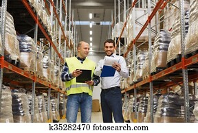 worker and businessmen with clipboard at warehouse worker and businessmen with clipboard at warehouse