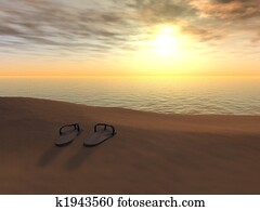 Flip flops on a beach at sunset.