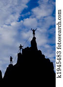 Team of climbers reaching the summit. 