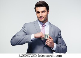Businessman putting money in pocket Businessman putting money in pocket