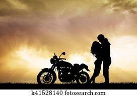 couple kissing on motorcycle couple kissing on motorcycle