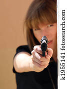 woman pointing gun at goldfish stock photo