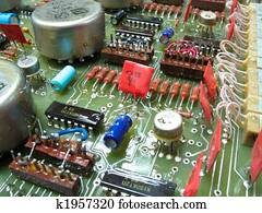 old circuit board from the 80th with colored electronic pieces