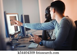 Programmers cooperating at information technology company Programmers cooperating at information technology company