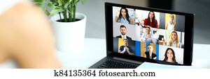 Woman talking with international colleagues using online video chat service Woman talking with international colleagues using online video chat service