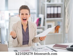 Happy business woman with document rejoicing