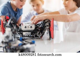 Busy interested children using robotics Busy interested children using robotics