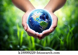 earth in hands - grass background earth in hands - grass background