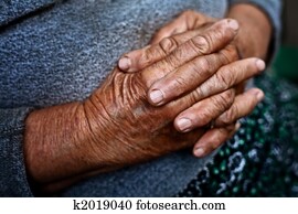 Detail on old hands of senior wrinkled woman