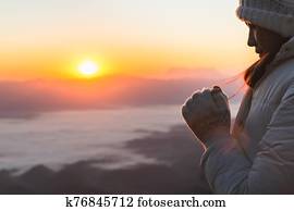 Young woman praying with hand, prayer concept for faith, spirituality and religion