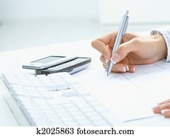 Female hand writing on paper