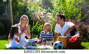 Happy family enjoying the sun in a picnic Happy family enjoying the sun in a picnic