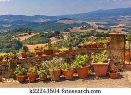 View from large garden over grassy hilltop in Italian countryside