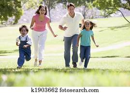 Family running outdoors smiling