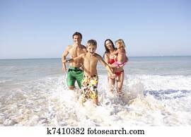 Young family play on beach