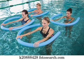 Fitness class doing aqua aerobics w Fitness class doing aqua aerobics w