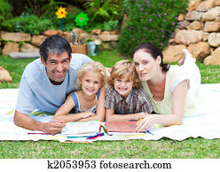 Happy family drawing in a park Happy family drawing in a park