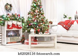 Decorated fireplace in a home with Christmas tree Decorated fireplace in a home with Christmas tree
