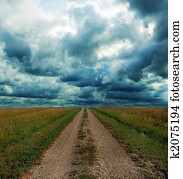 Dirt Road Through the Prairie in Storm