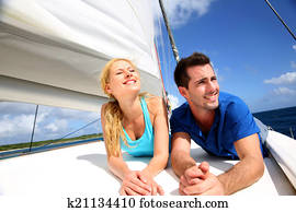 https://cdn-grid.fotosearch.com/CSP/CSP207/smiling-couple-relaxing-on-a-yacht-by-stock-photography__k21134410.jpg