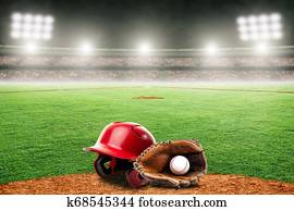 Baseball Glove, Ball, and Helmet on Field in Outdoor Stadium With Copy Space