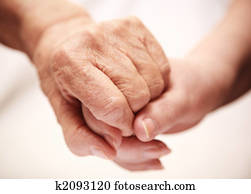 adult helping senior in hospital